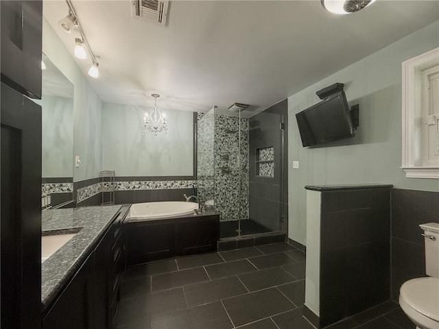 4612 Lorino St, Metairie, LA 70006 - full bath with a bath, vanity, a shower stall, tile patterned floors, and toilet