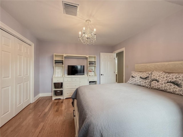 4612 Lorino St, Metairie, LA 70006 - bedroom with a chandelier, wood finished floors, baseboards, and a closet