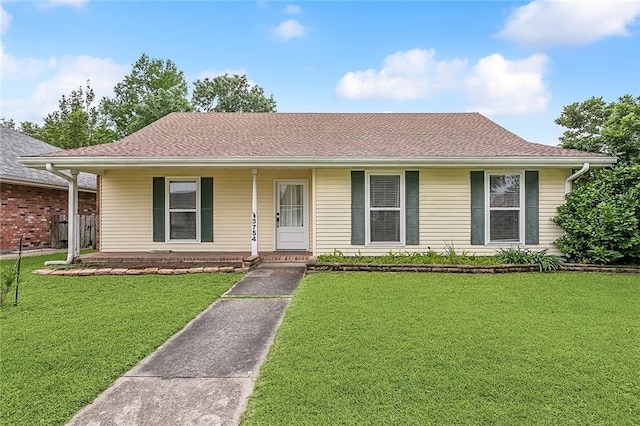 3754 Ashton Dr, Destrehan, LA 70047 - ranch-style house with a front lawn, roof with shingles, and a porch