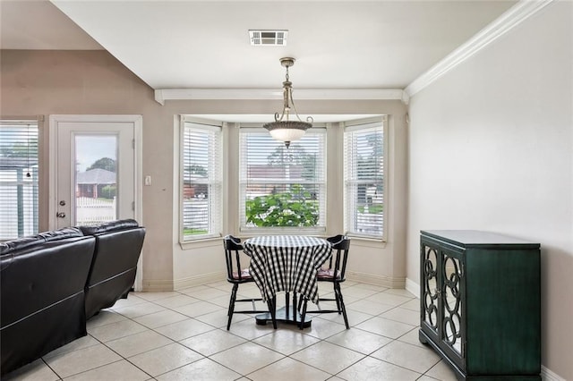 dining area with baseboards, visible vents, light tile patterned floors, and crown molding