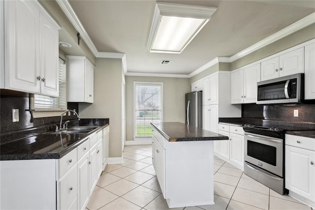 kitchen featuring white cabinets, stainless steel appliances, visible vents, and a sink