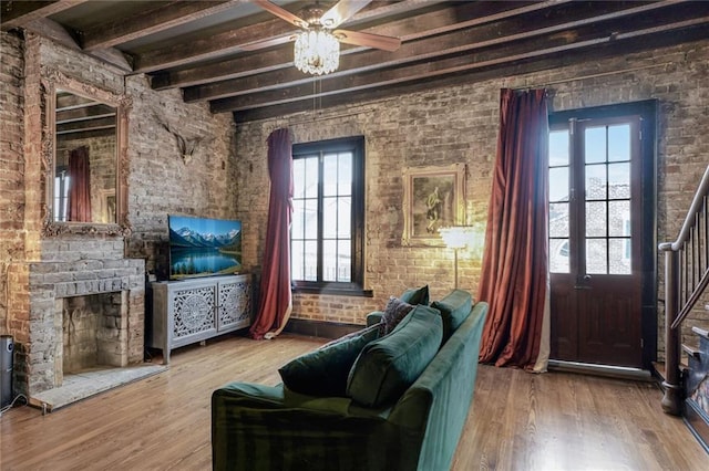 1201 Decatur St Unit D, New Orleans, LA 70116 - living room with beam ceiling, a fireplace with raised hearth, wood finished floors, a ceiling fan, and stairway