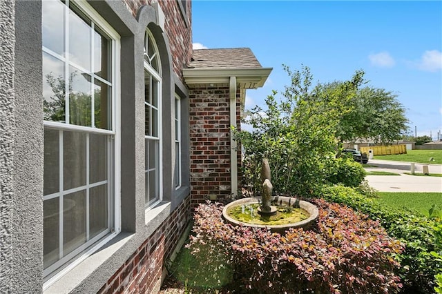 view of home's exterior with stucco siding and brick siding