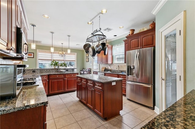 kitchen with stainless steel appliances, dark brown cabinets, a sink, visible vents, and crown molding