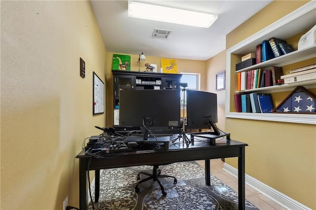 office area featuring visible vents, tile patterned flooring, and baseboards