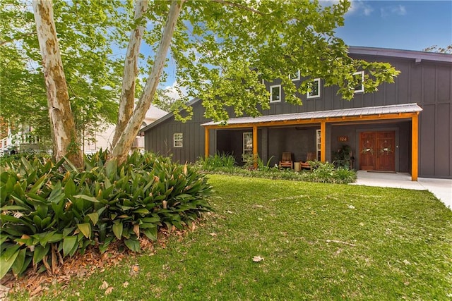 view of front facade featuring a front yard and board and batten siding
