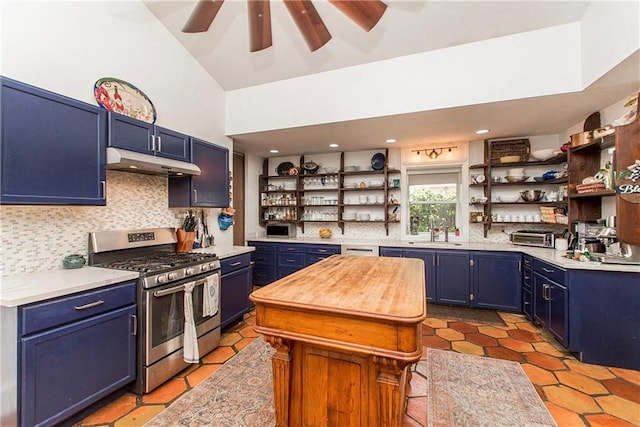 kitchen with open shelves, blue cabinetry, under cabinet range hood, and gas stove