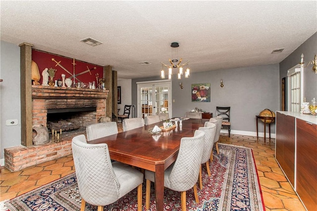 dining area featuring a textured ceiling, visible vents, and a wealth of natural light