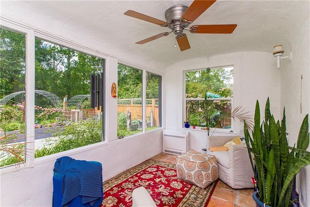 sunroom with heating unit and plenty of natural light