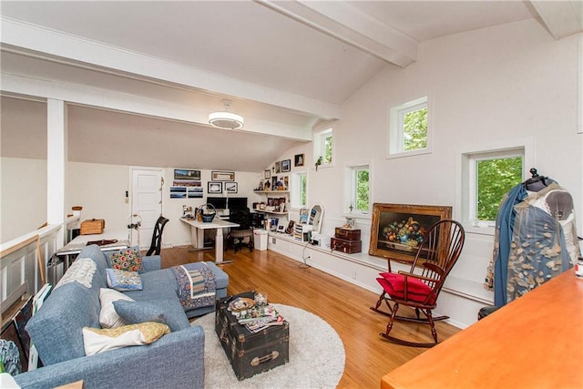 living area featuring lofted ceiling with beams and wood finished floors
