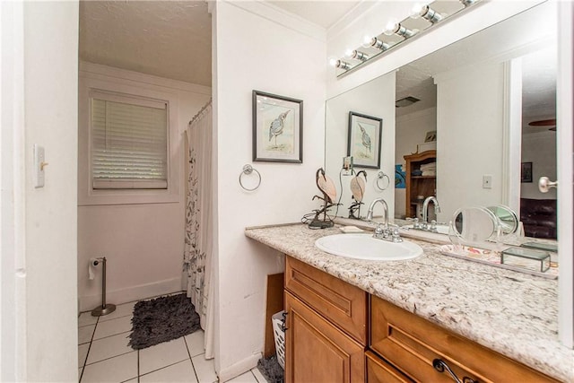 full bath featuring baseboards, tile patterned flooring, crown molding, and vanity