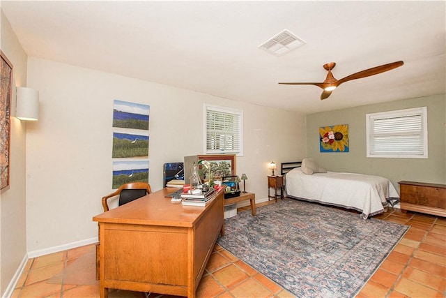bedroom featuring light tile patterned floors, a ceiling fan, visible vents, and baseboards