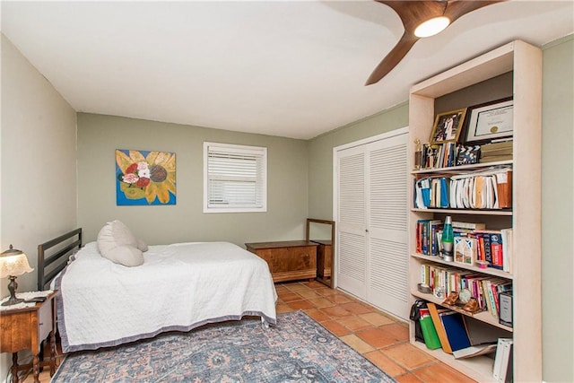 bedroom featuring tile patterned flooring, a closet, and ceiling fan