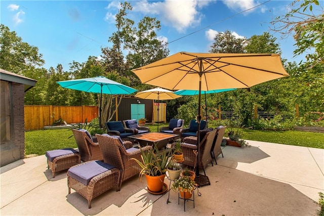 view of patio with an outdoor living space and a fenced backyard