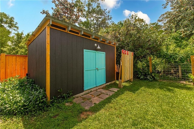 view of shed featuring fence