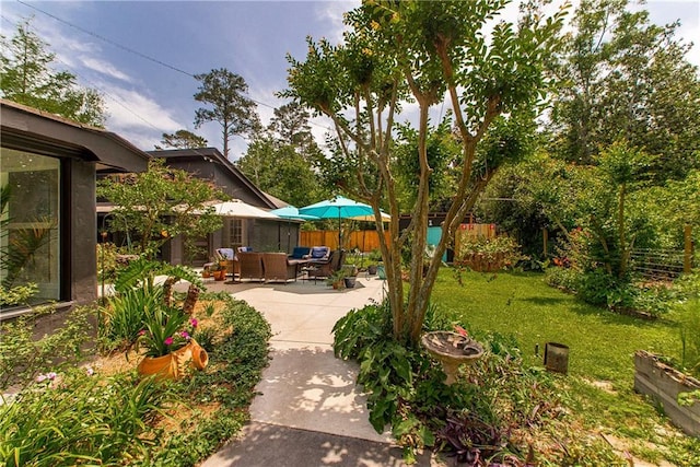 view of yard with fence, a patio area, and an outdoor hangout area
