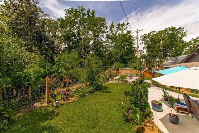 view of yard featuring fence and a patio area