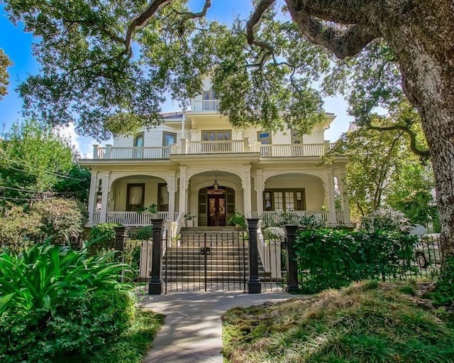 1711 Palmer Ave, New Orleans, LA 70118 - view of front of property featuring a balcony, covered porch, french doors, and stucco siding