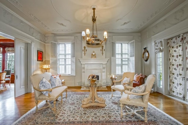 1711 Palmer Ave, New Orleans, LA 70118 - sitting room featuring a chandelier, wood finished floors, healthy amount of natural light, and crown molding