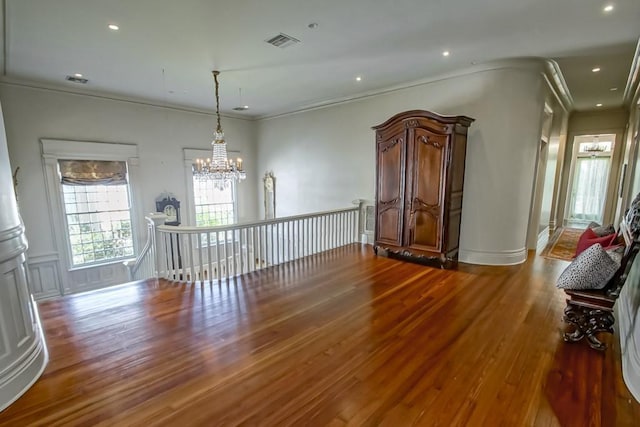 1711 Palmer Ave, New Orleans, LA 70118 - spare room featuring a chandelier, wood finished floors, crown molding, and recessed lighting