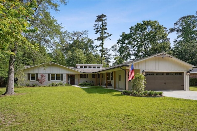 view of front facade with a front yard, driveway, and an attached garage