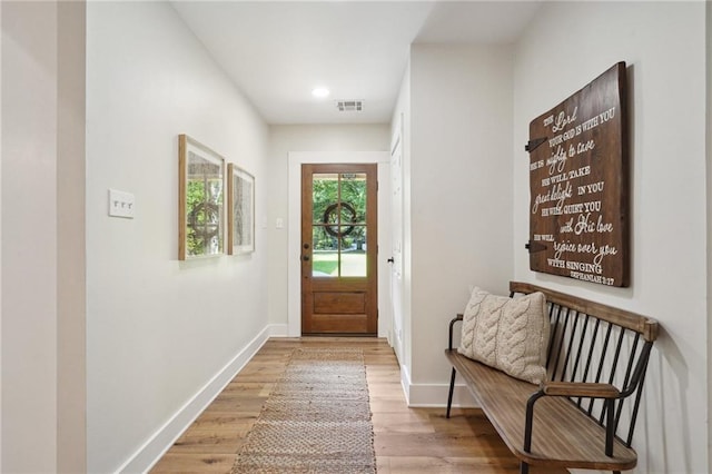 doorway to outside with visible vents, light wood-style floors, recessed lighting, and baseboards