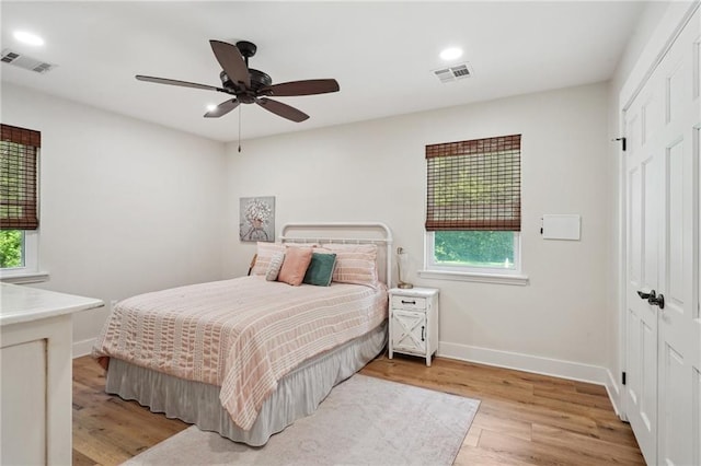 bedroom with visible vents, multiple windows, and a closet
