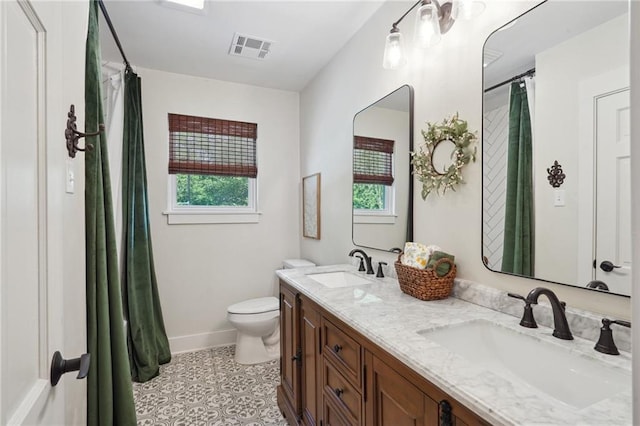 full bathroom with visible vents, toilet, baseboards, and a sink