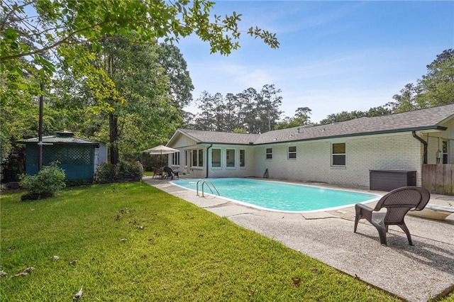 outdoor pool with a yard, a gazebo, and a patio area