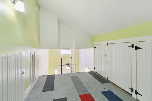 interior space featuring visible vents and vaulted ceiling