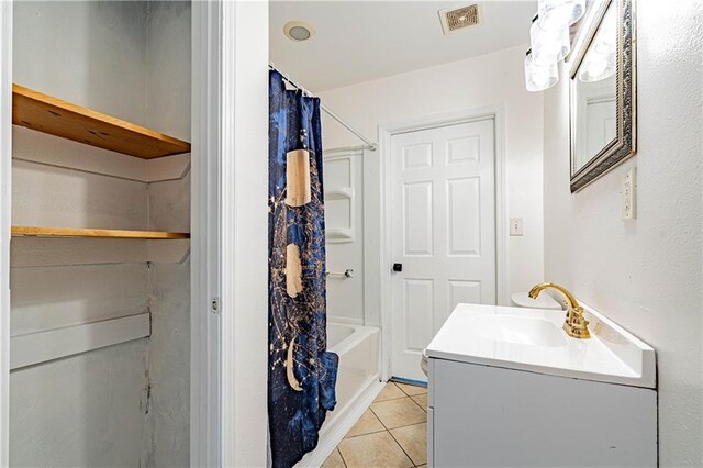 full bath with tile patterned floors, vanity, and shower / bath combo