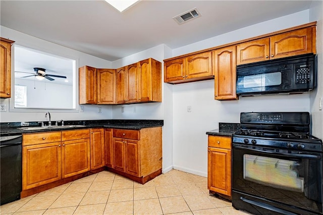 kitchen featuring black appliances, a sink, and brown cabinets