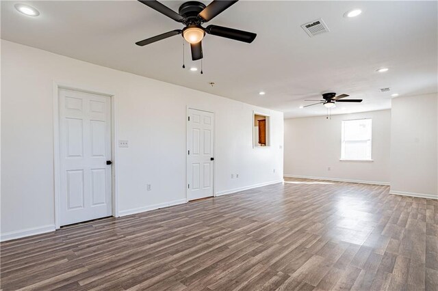 spare room with a ceiling fan, wood finished floors, recessed lighting, and baseboards
