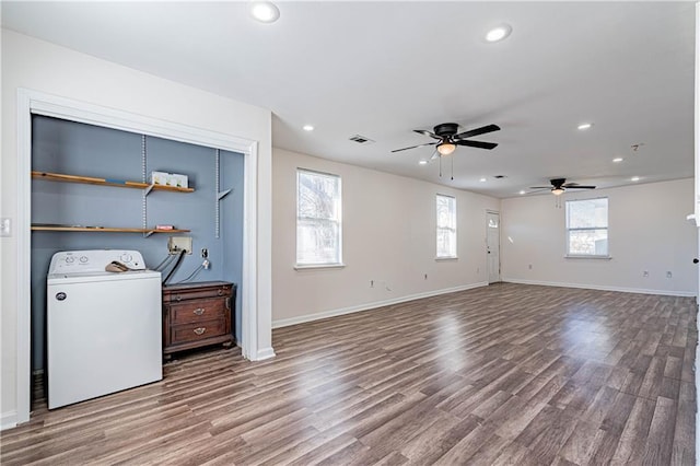 unfurnished living room with washer / dryer, ceiling fan, wood finished floors, recessed lighting, and baseboards
