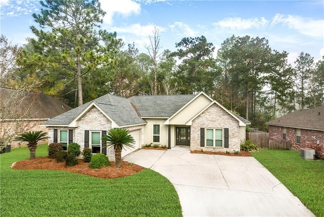 view of front of property featuring fence, a front yard, brick siding, an attached garage, and driveway