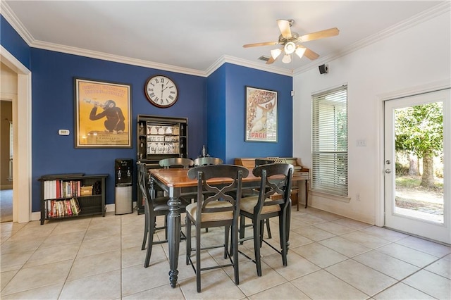 dining space with crown molding, ceiling fan, and light tile patterned floors