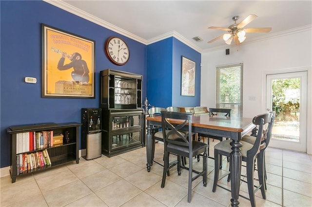 dining room with a ceiling fan, visible vents, ornamental molding, and tile patterned flooring