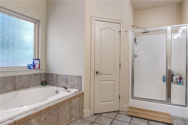 bathroom with tile patterned floors, a garden tub, and a stall shower