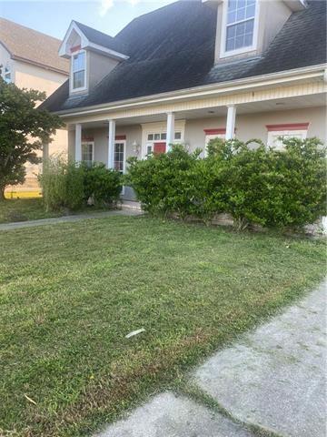 103 Warwick St, La Place, LA 70068 - cape cod house featuring a front yard and stucco siding