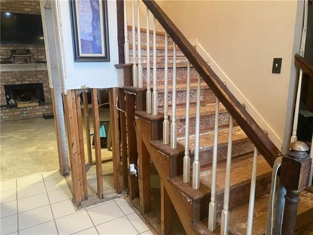 103 Warwick St, La Place, LA 70068 - staircase with tile patterned floors and a fireplace