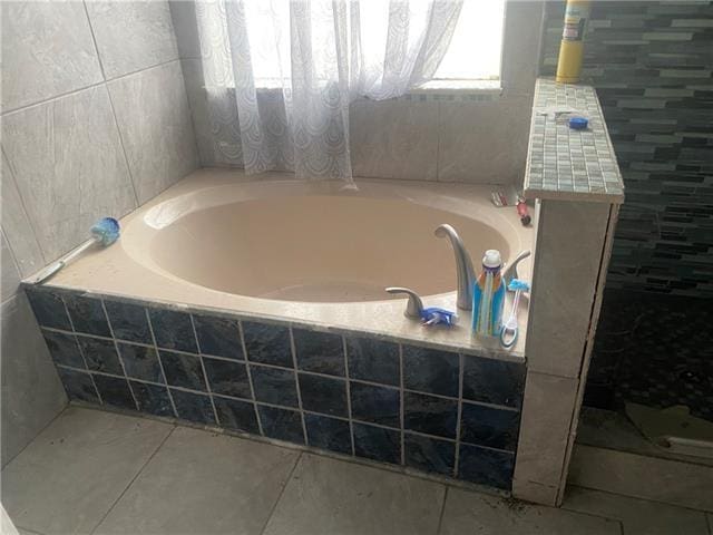 103 Warwick St, La Place, LA 70068 - bathroom featuring a garden tub, tile patterned floors, and a tile shower