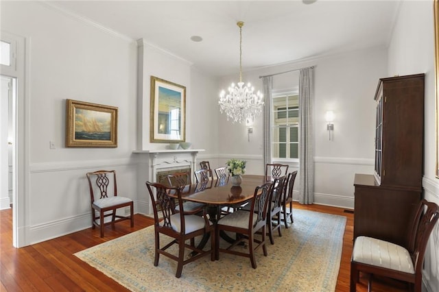 5934 Chestnut St, New Orleans, LA 70118 - dining area with ornamental molding, a notable chandelier, wood finished floors, and baseboards