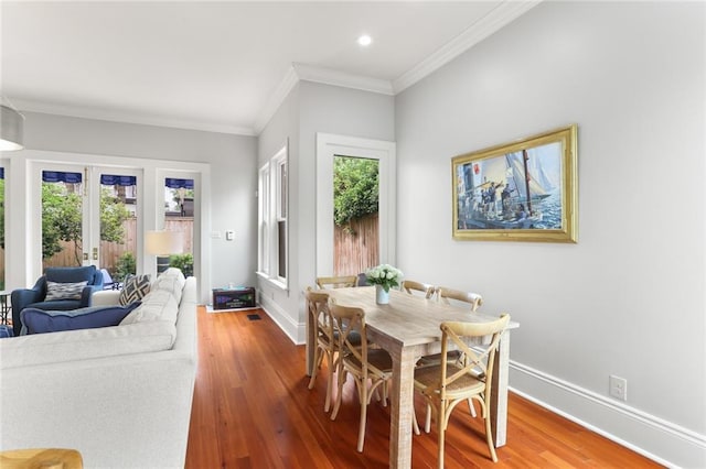 5934 Chestnut St, New Orleans, LA 70118 - dining room featuring crown molding, recessed lighting, wood finished floors, and baseboards