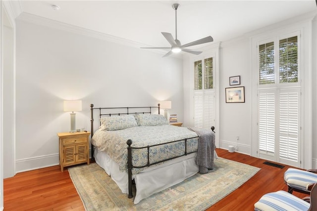 5934 Chestnut St, New Orleans, LA 70118 - bedroom with wood finished floors, baseboards, visible vents, a ceiling fan, and crown molding