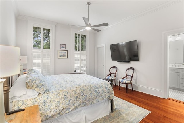 5934 Chestnut St, New Orleans, LA 70118 - bedroom with baseboards, wood finished floors, ornamental molding, and a sink