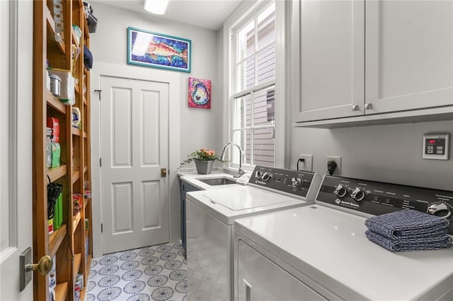 5934 Chestnut St, New Orleans, LA 70118 - clothes washing area with washing machine and dryer, cabinet space, and a sink