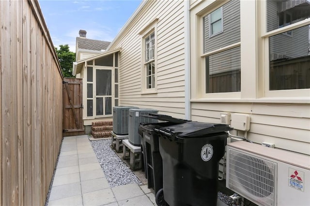 5934 Chestnut St, New Orleans, LA 70118 - view of side of property with fence, central air condition unit, and ac unit