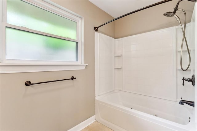 full bath featuring baseboards, tile patterned flooring, and tub / shower combination