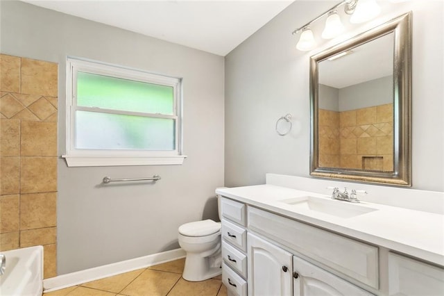 bathroom with baseboards, toilet, tile patterned flooring, and vanity