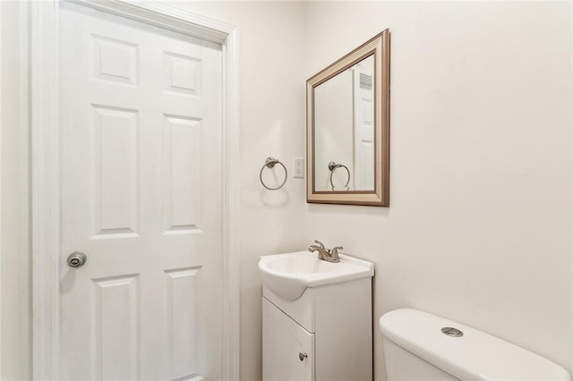 bathroom with toilet and vanity